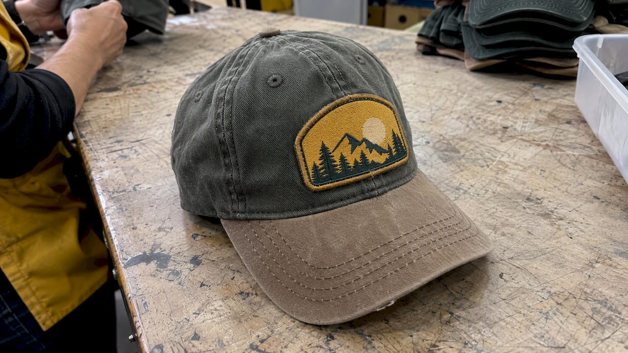 Sewn patch edge on a worn cap